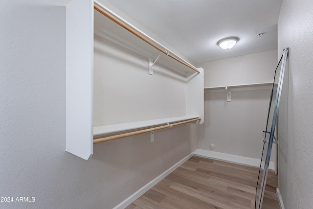 walk in closet featuring light hardwood / wood-style flooring