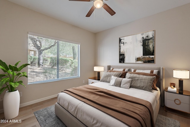 bedroom with ceiling fan and light wood-type flooring