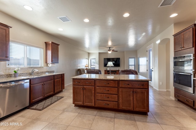 kitchen featuring a sink, visible vents, stainless steel appliances, and open floor plan
