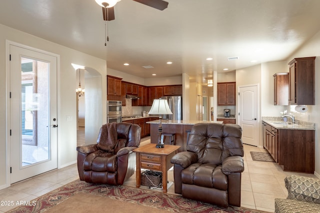 living area with a ceiling fan, visible vents, recessed lighting, and light tile patterned floors