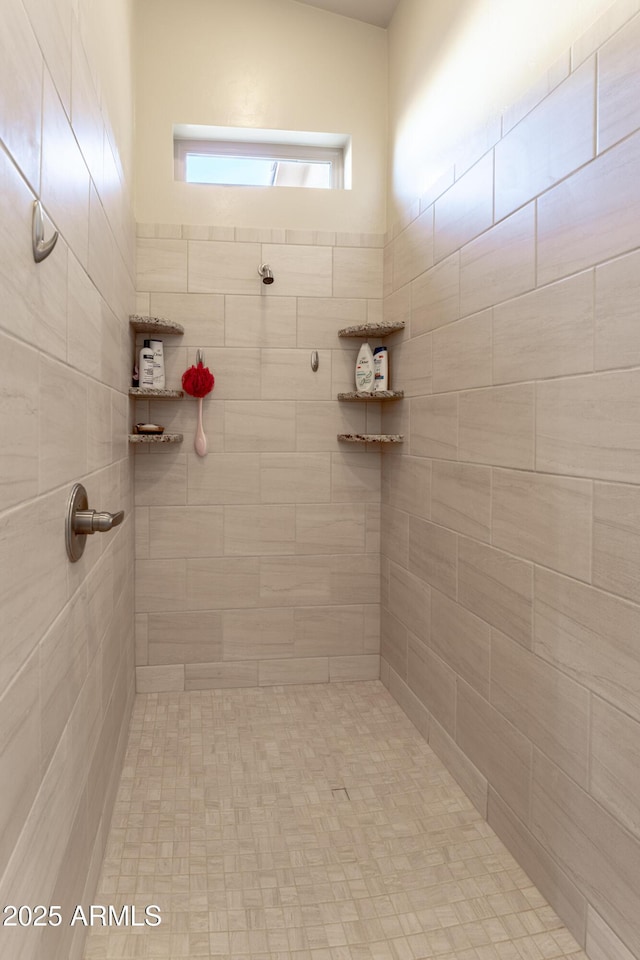 bathroom with a tile shower