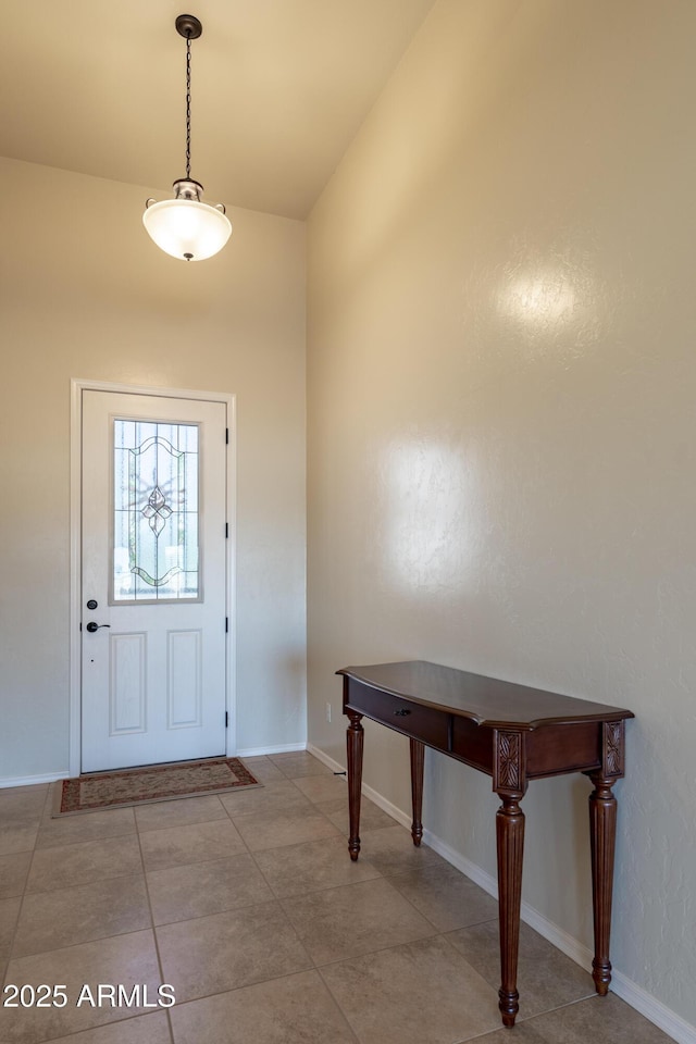tiled foyer entrance featuring baseboards