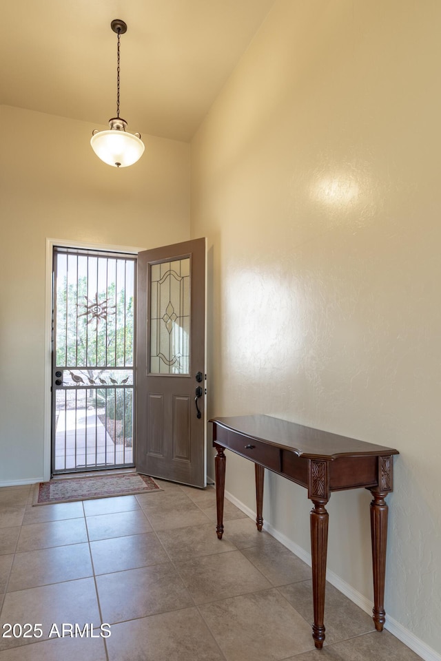 entryway featuring tile patterned flooring and baseboards