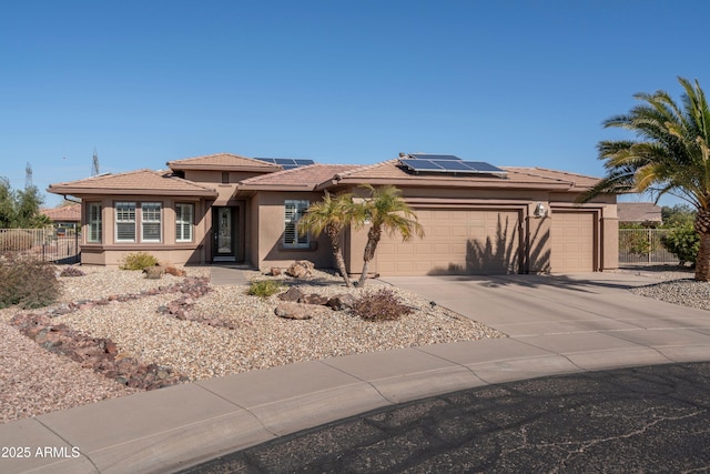 view of front of house featuring a garage and solar panels