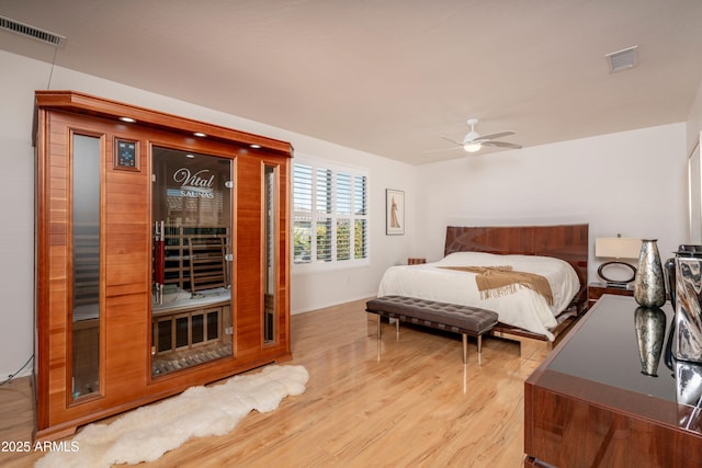 bedroom with ceiling fan and light wood-type flooring