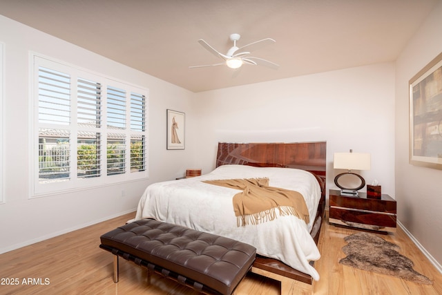 bedroom with ceiling fan and hardwood / wood-style floors