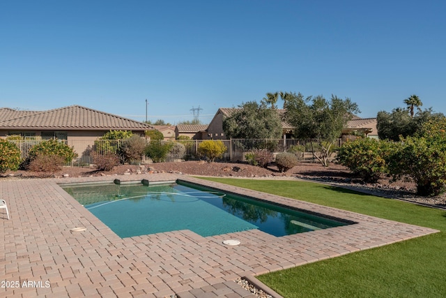 view of pool with a lawn