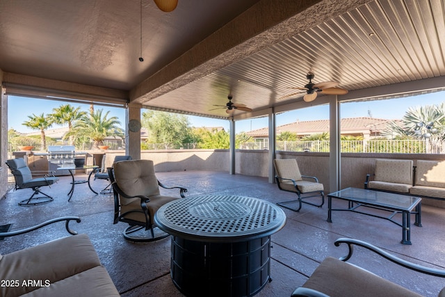 view of patio / terrace with an outdoor living space, area for grilling, and ceiling fan