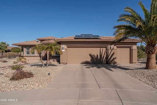 view of front facade featuring a garage and solar panels