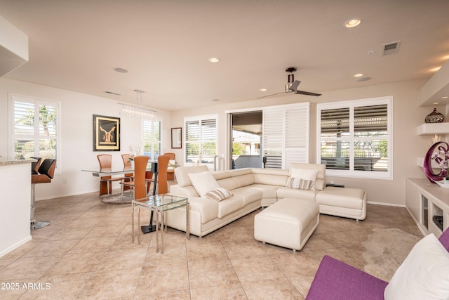 tiled living room featuring a wealth of natural light and ceiling fan