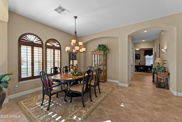 tiled dining space with a notable chandelier