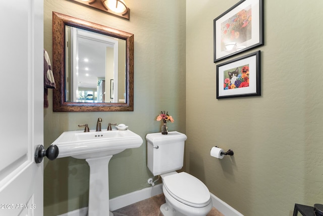 bathroom featuring toilet and sink