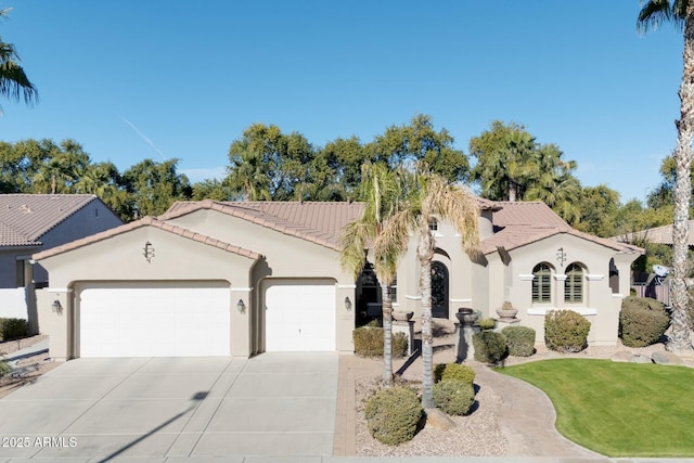 mediterranean / spanish house with a front lawn and a garage