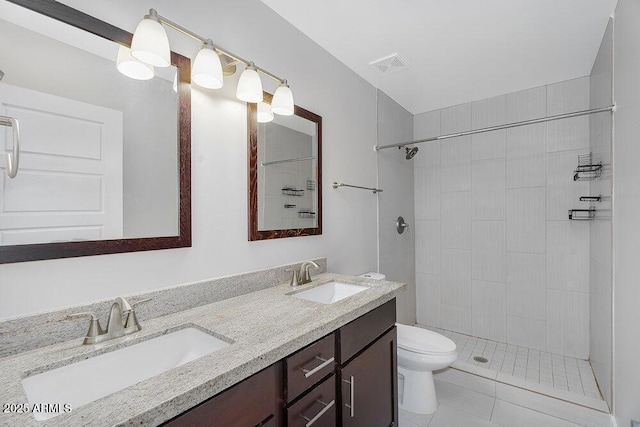 full bathroom featuring a sink, visible vents, toilet, and double vanity