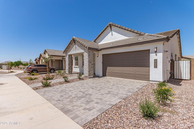 19434 S 212th Pl, Queen Creek, AZ 85142 - ranch-style house with stucco siding, decorative driveway, a garage, a tile roof, and stone siding