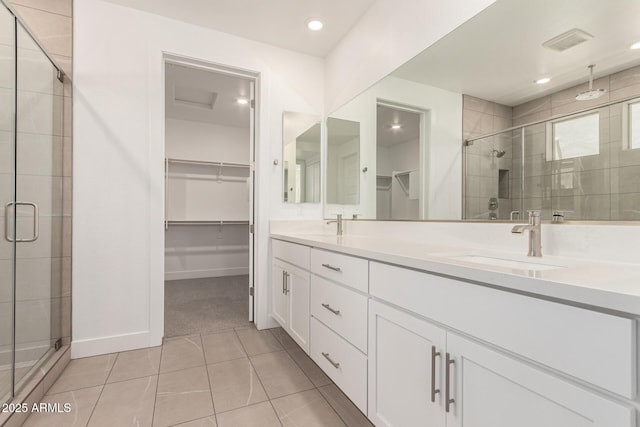 19434 S 212th Pl, Queen Creek, AZ 85142 - bathroom featuring a spacious closet, a stall shower, double vanity, tile patterned flooring, and recessed lighting