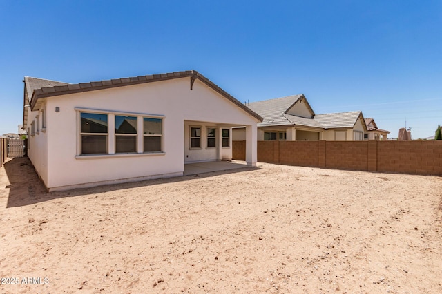 19434 S 212th Pl, Queen Creek, AZ 85142 - rear view of house featuring a fenced backyard, a patio, stucco siding, and a tile roof