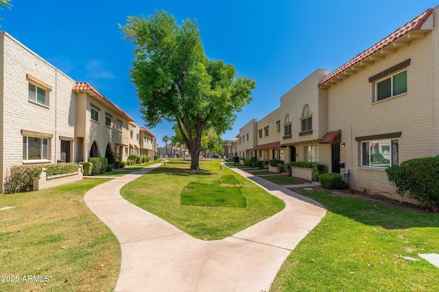 view of community featuring a residential view and a lawn