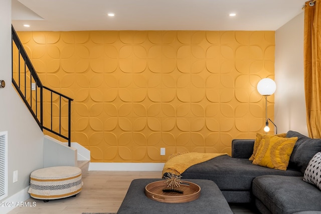living area featuring recessed lighting, stairway, and wood finished floors