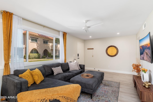 living room featuring visible vents, baseboards, recessed lighting, light wood finished floors, and a ceiling fan
