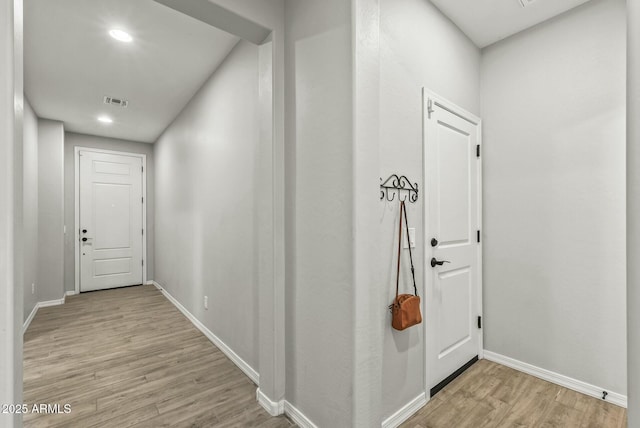hall with recessed lighting, baseboards, visible vents, and light wood-style flooring