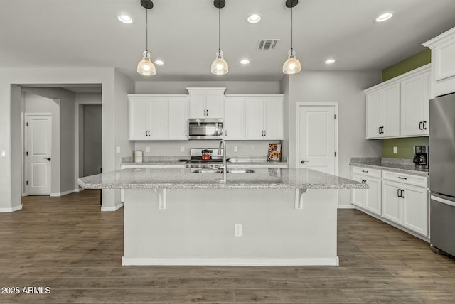 kitchen featuring white cabinets, visible vents, a sink, and appliances with stainless steel finishes