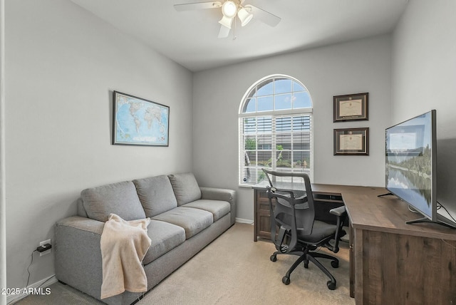 office area with ceiling fan, light carpet, and baseboards