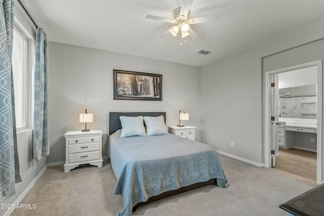 bedroom with baseboards, visible vents, and light colored carpet
