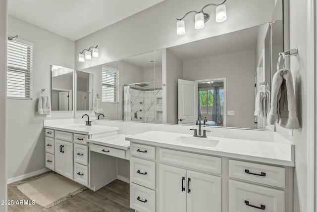 bathroom featuring a shower stall, vanity, and wood finished floors