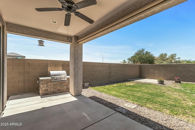 view of patio / terrace featuring exterior kitchen, a ceiling fan, a fenced backyard, and a grill