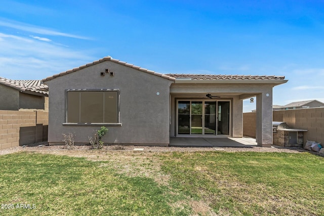 rear view of house with a lawn, fence, a ceiling fan, and a patio