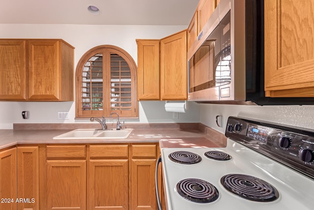 kitchen with white range with electric cooktop and sink