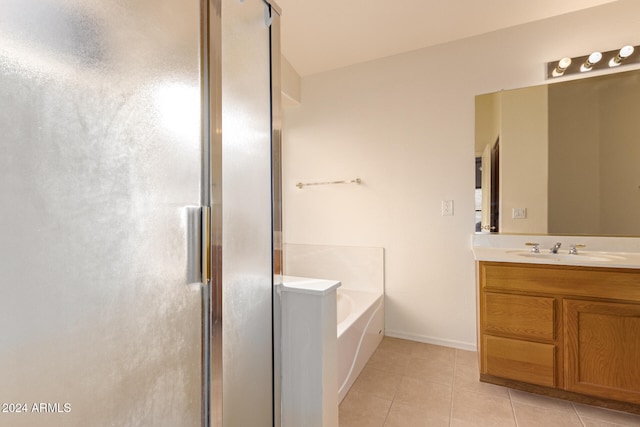 bathroom with tile patterned flooring, vanity, and plus walk in shower