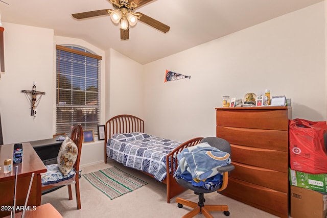 bedroom featuring ceiling fan, light carpet, and vaulted ceiling