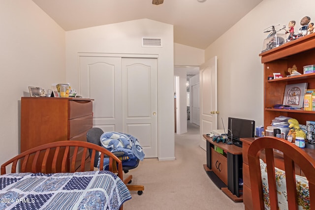 carpeted bedroom featuring a closet and vaulted ceiling