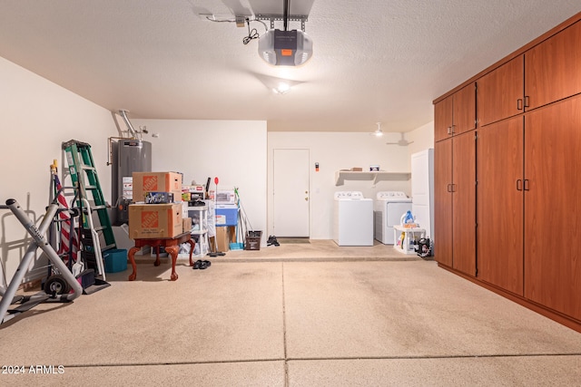 garage with a garage door opener, gas water heater, and separate washer and dryer