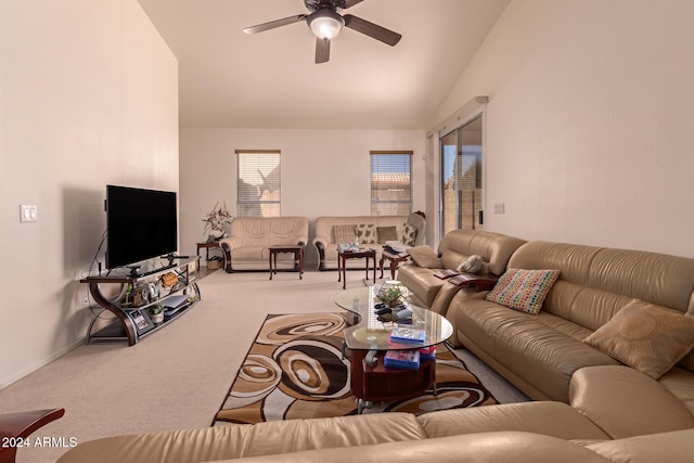 carpeted living room with ceiling fan and lofted ceiling