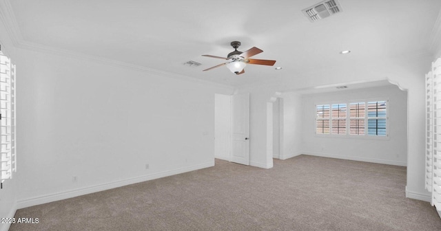 spare room featuring crown molding, light carpet, and ceiling fan