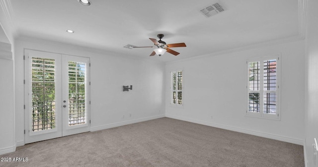 unfurnished room featuring crown molding, light carpet, and french doors