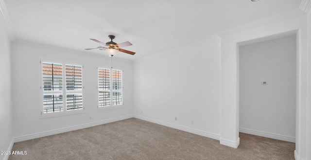 carpeted spare room featuring ornamental molding and ceiling fan