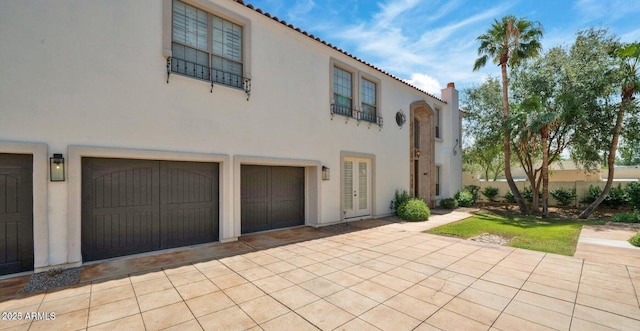 mediterranean / spanish home featuring a garage