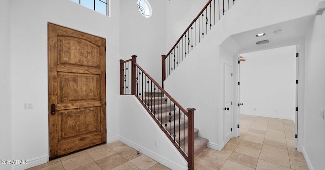 tiled foyer with a high ceiling