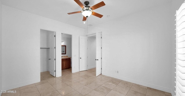 unfurnished bedroom featuring ensuite bathroom and ceiling fan