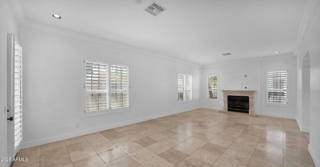 unfurnished living room with a fireplace, ornamental molding, and a healthy amount of sunlight