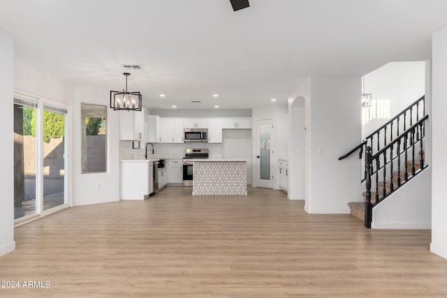 living room with light hardwood / wood-style flooring and sink