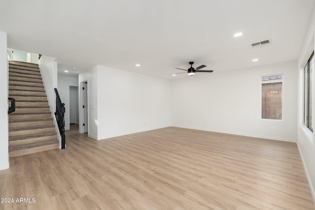 unfurnished living room with light wood-type flooring and ceiling fan