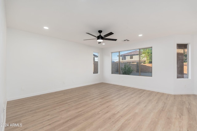 spare room featuring ceiling fan and light wood-type flooring