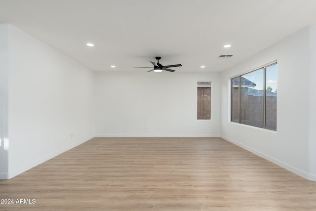 spare room featuring light hardwood / wood-style floors and ceiling fan