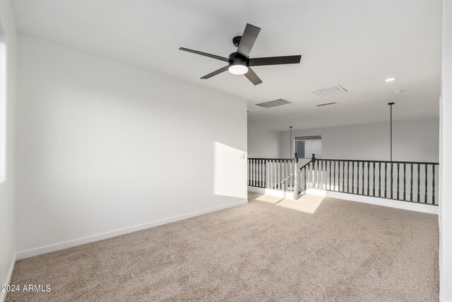 carpeted empty room featuring ceiling fan