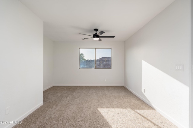 empty room featuring carpet flooring and ceiling fan